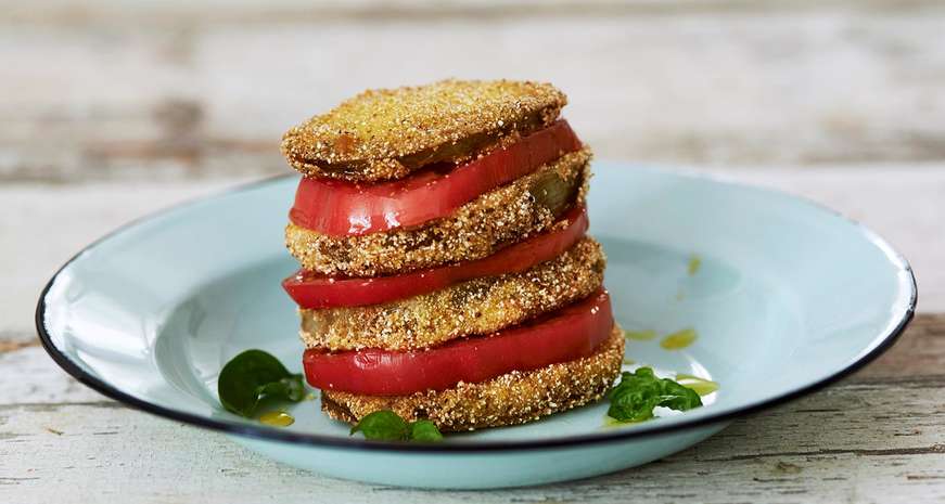 Fried green tomatoes stacked with ripe red tomatoes