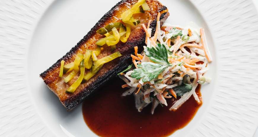 Slow-cooked bacon with kohlrabi slaw and Aunt Julia's BBQ sauce