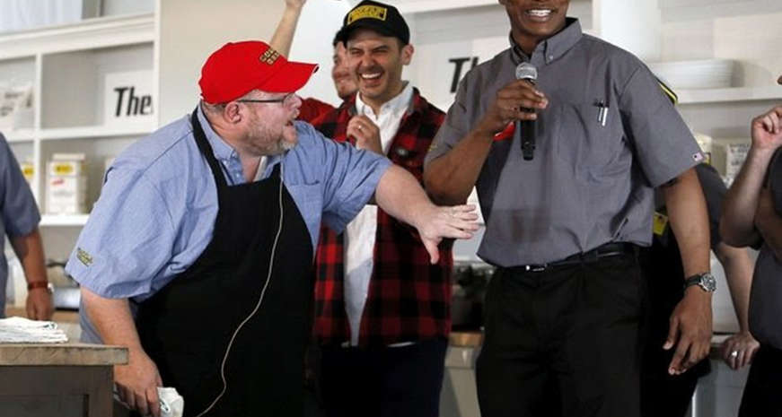 Chris Hall, in red cap, onstage at a chef's battle