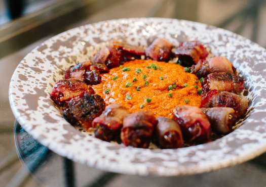 Bacon-Wrapped, Andouille-Stuffed Dates with Pecan Romesco Sauce
